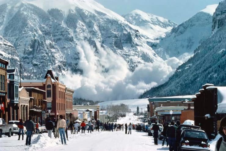 Color photograph of telluride's main street with an avalanche on the distant mountains taken by slate gray gallery artist Bill Ellzey