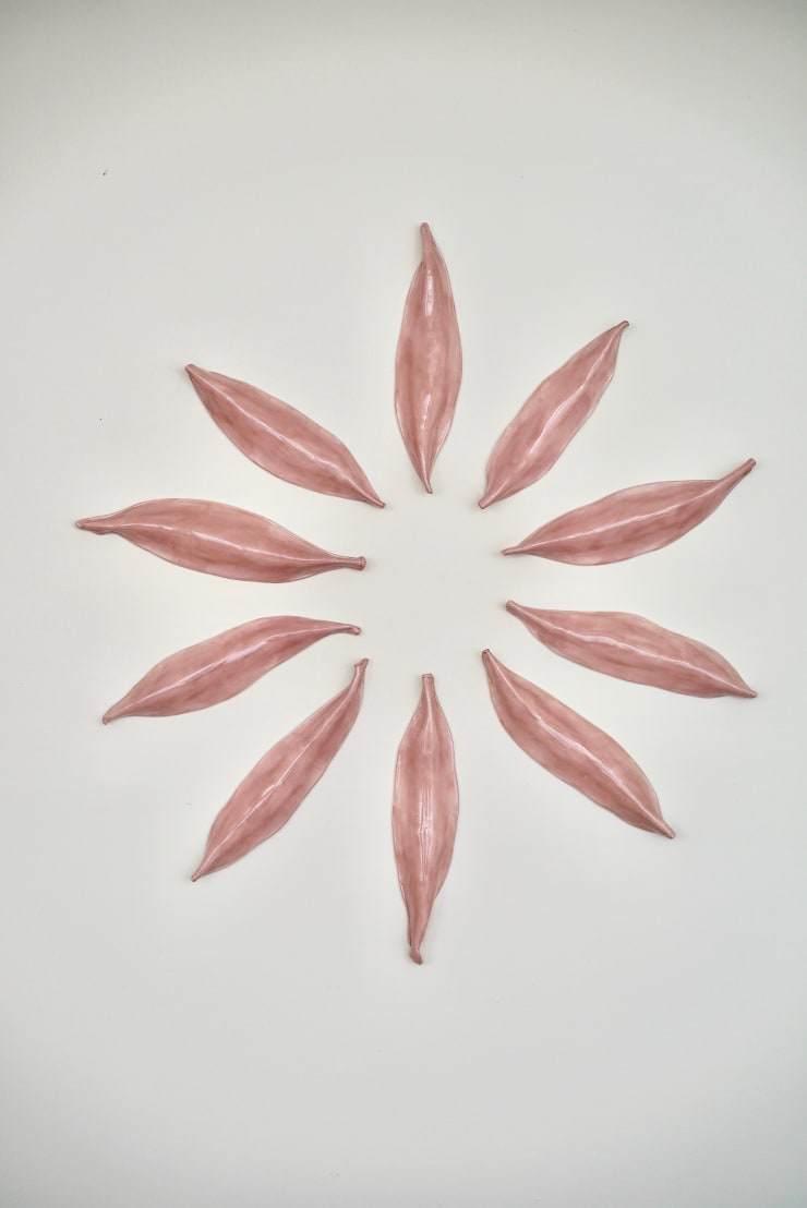 Pink Ceramic petals that can be arranged in multiple ways by slate gray gallery artist Angela Okajima-Kempinas