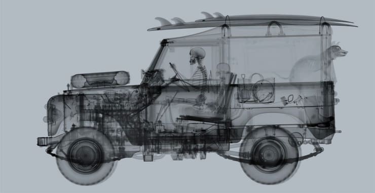 Nick Veasey X-ray photo of land rover with surf board and dog on grey background
