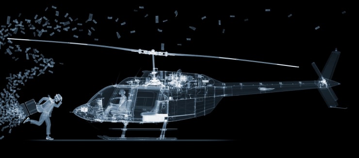 Nick Veasey X-ray photograph of helicopter and man running towards it with open briefcase and cash flying out
