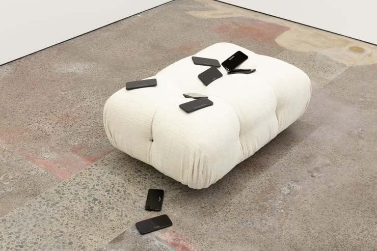 Matthew Galloway Watch History (Camaleonda Enia Ivory), 2025 Engraved replica iPhone 16 handsets, B&B Italia Camaleonda ottoman 40 x 125 x 63 cm 15 3/4 x 49 1/4 x 24 3/4 in