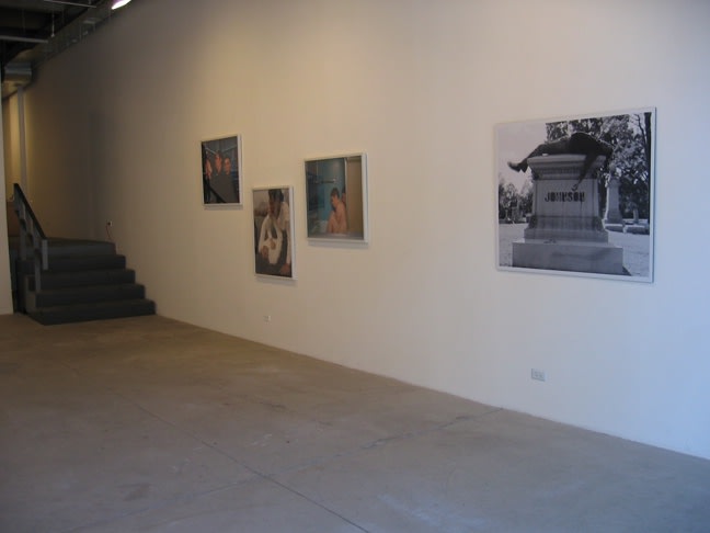 Left to right: Carrie Schneider, Untitled (Library), Untitled (Woodchips), and Untitled (Tub) from the series Derelict Self, 2006-2007, c-prints, 30 x 36 inches each. Rashid Johnson, Self Portrait laying on Jack Johnson's Gave, 2006, Durst Lambda print mounted on Sintra with UV laminate 40.5 x 49.5 inches.