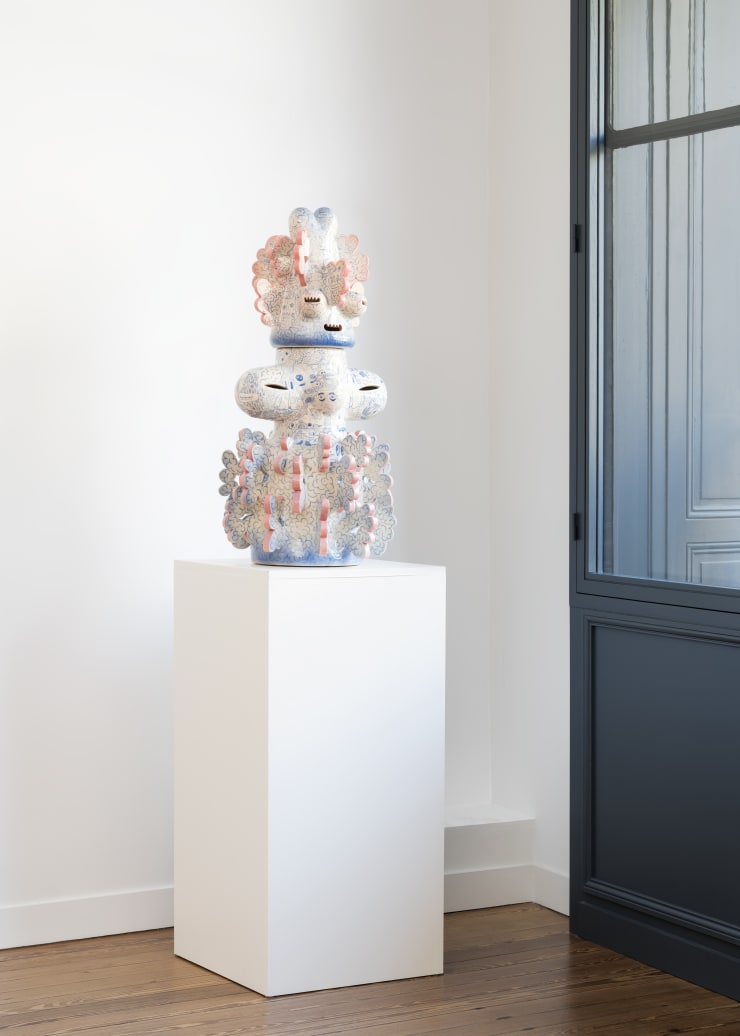 Ceramic sculpture by Kartini Thomas titled “Tattooed Space Monkey” (2025), a biomorphic, spiritually infused figure glazed in pastel tones.