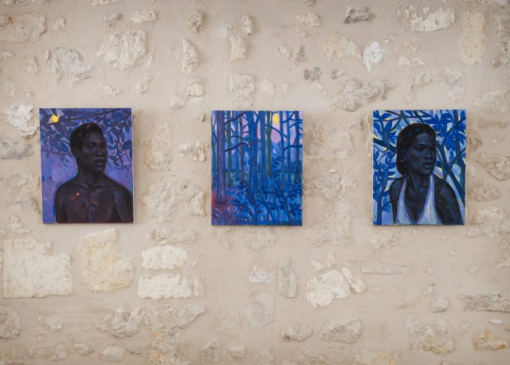 Installation view of three paintings by Stephen Price — Within the Blue Forest, The Blue Trees, and The Hidden Light — shown on a stone wall