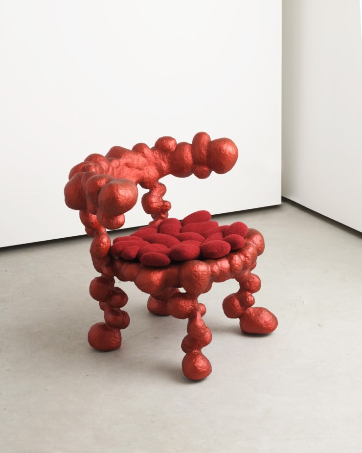 Red collectible chair designed by Humberto da Mata
