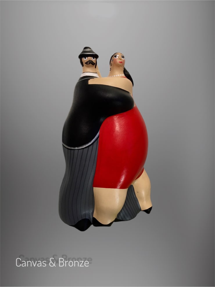 Sculpture of a stylized couple dancing, featuring exaggerated round forms and vibrant colors, with a man in a black suit and a woman in a red dress.