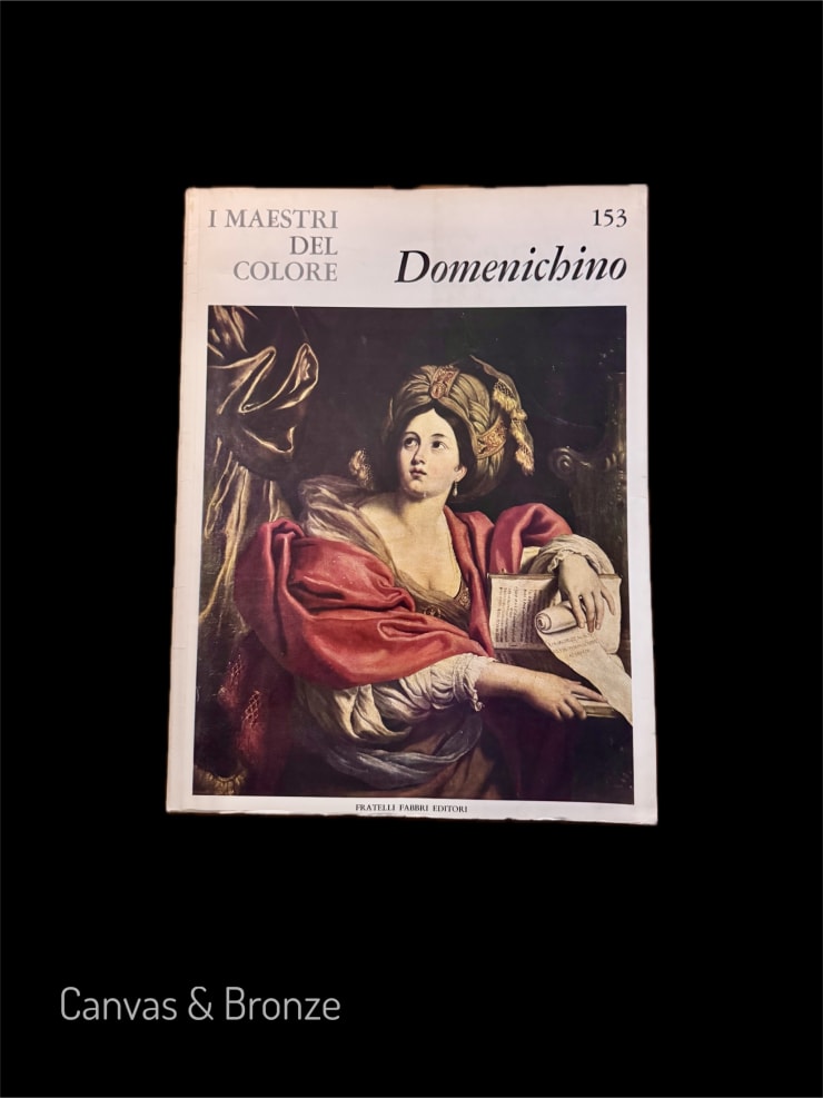 Cover of "I Maestri Del Colore" featuring Domenichino's artwork depicting a woman in a red robe with a feathered headpiece, holding a book and a quill, against a dark background.