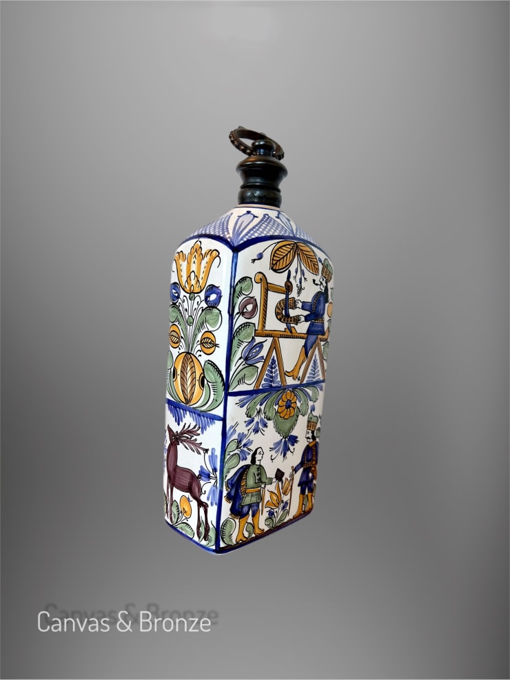 Decorative ceramic bottle with intricate, colorful designs featuring floral and figurative motifs against a gray background.