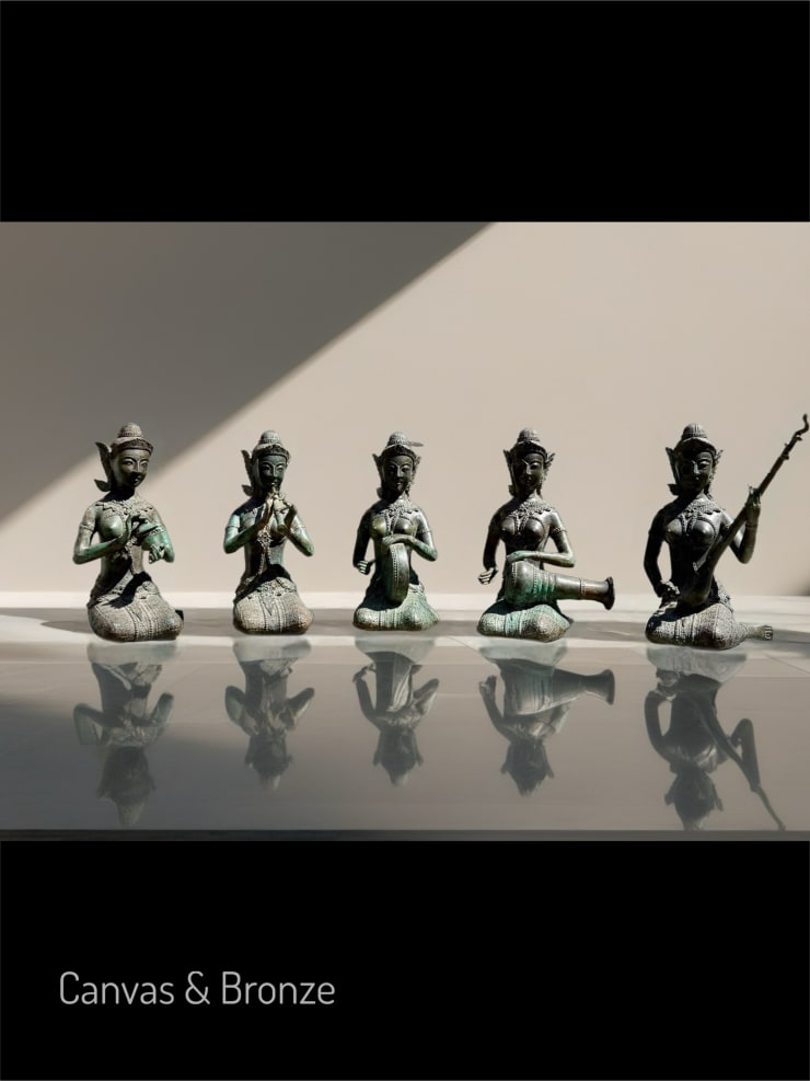 Five bronze figurines of musicians and dancers on a reflective surface, showcasing intricate cultural craftsmanship and detail, with a shadow cast in the background.