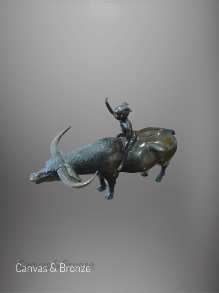 Bronze sculpture of a child riding a water buffalo, showcasing intricate details and a smooth patina finish.