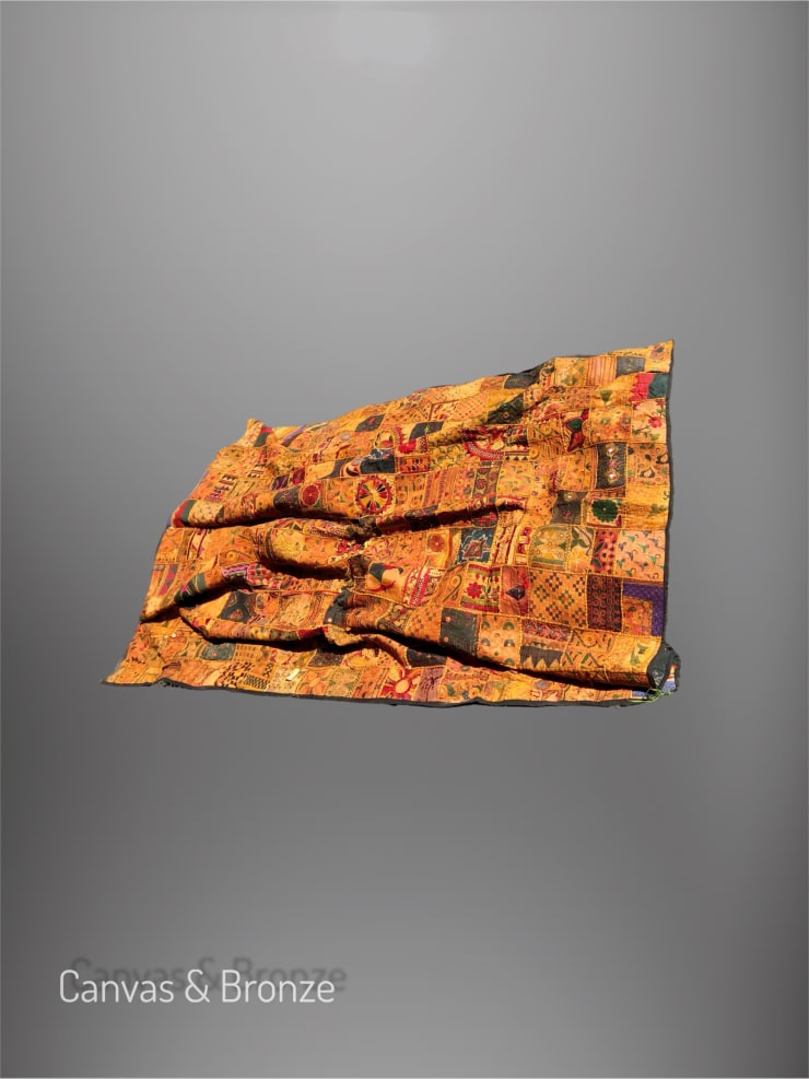 Colorful patchwork quilt with intricate geometric patterns and vibrant cultural motifs on a gray background.