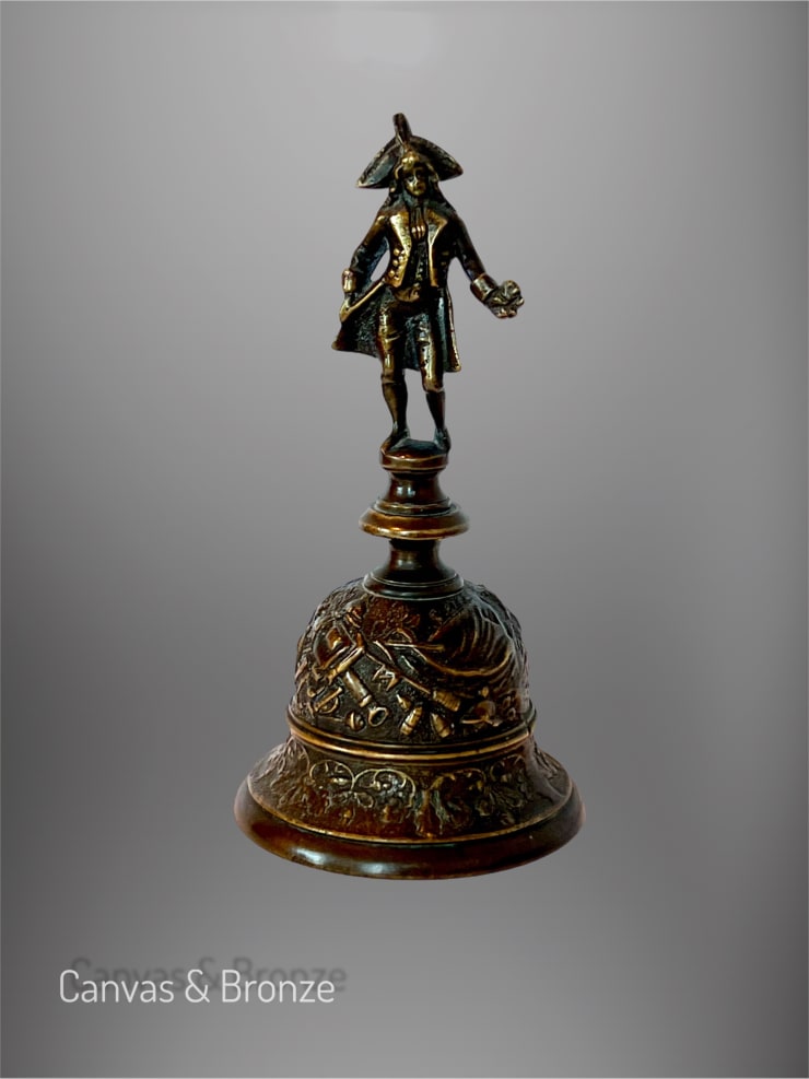 Bronze figurine of a historical figure in traditional attire on a decorative base.