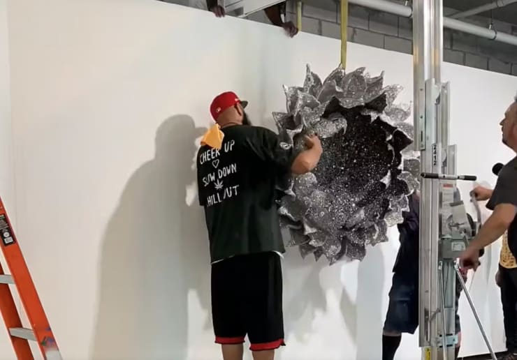Artists Lauren Fensterstock and Aaron Stephan installing artwork Heart of Negation at LOOP Overtown Miami