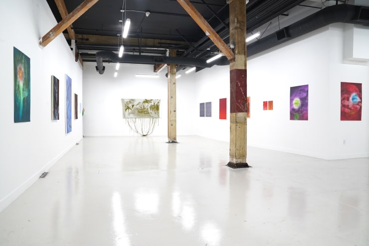 photo of the gallery layout with a monochromatic themed art exhibition installed