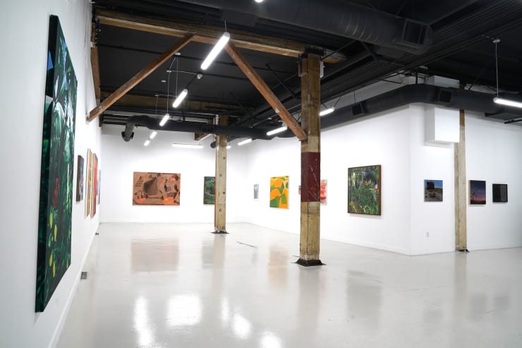photograph of the gallery with paintings on the walls