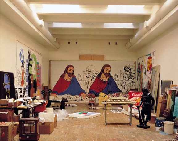Warhol’s studio with the plastic sculpture of Last Supper sitting on the table in the foreground.