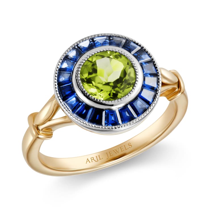 Aril Jewels x Fuli Gemstones peridot & sapphire Target ring from Clara collection in an Art Deco inspired design with precision cut sapphires. 18k yellow gold & platinum. On white background