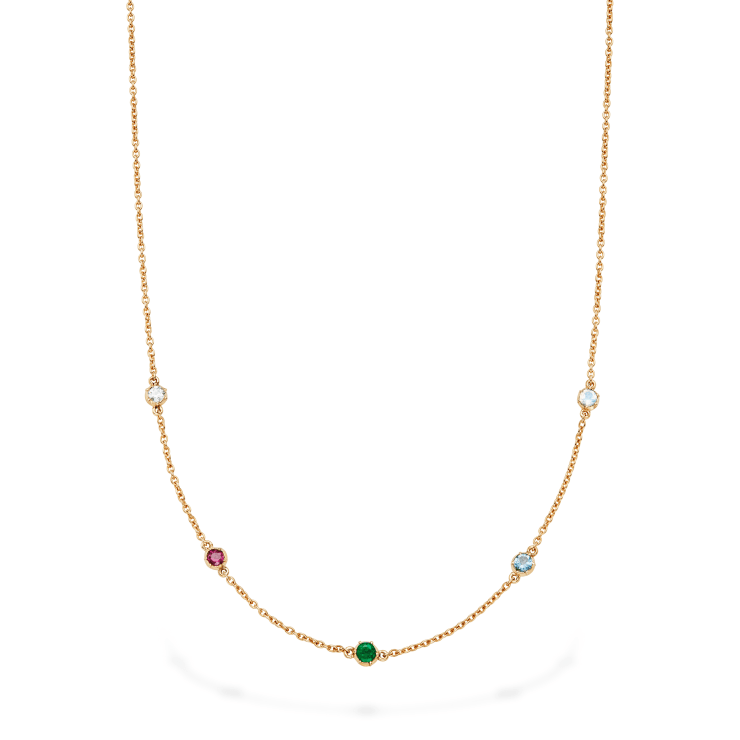 Yellow gold chain necklace with gemstones spelling out the word "dream" in cutdown style settings spaced out on a white background
