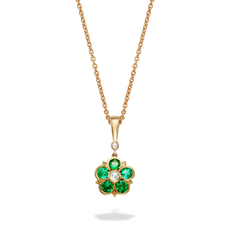 Emerald & diamond rose pendant from Elizabeth collection with emeralds & rose cut diamond in a floral motif. 18ct yellow gold. Pictured on a white background.