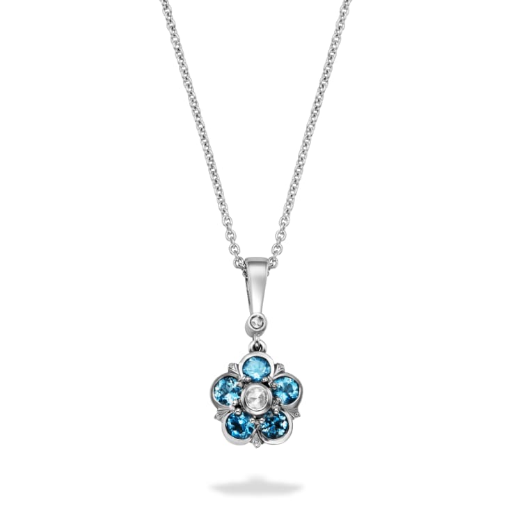 Aquamarine and diamond pendant in a floral motif set in platinum, which hangs from a diamond and bale.