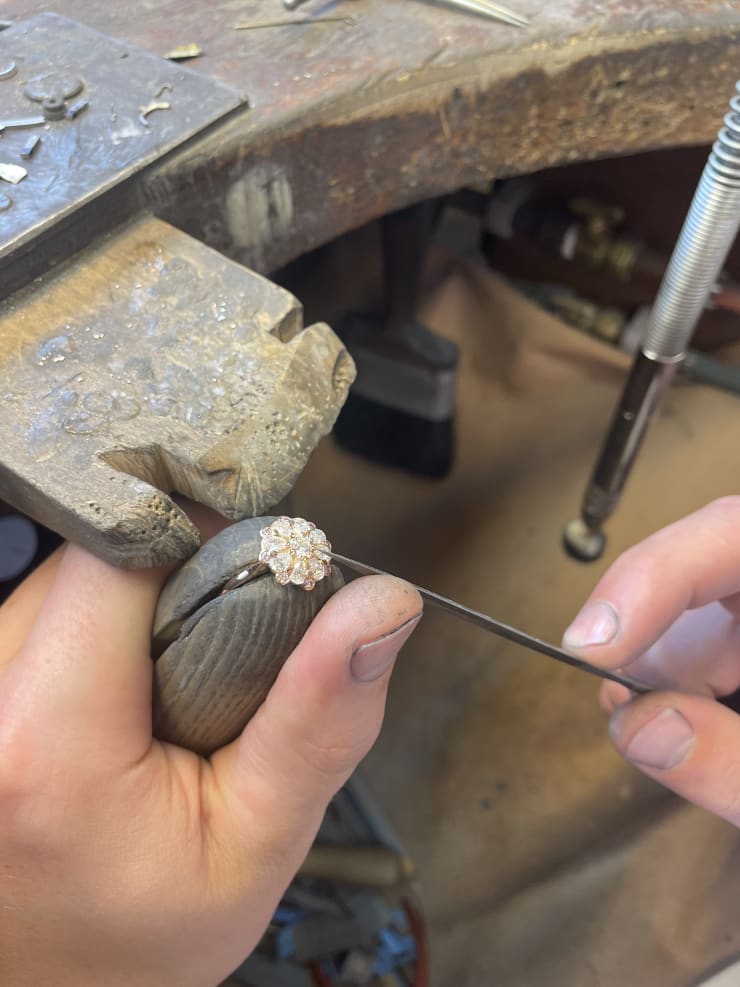 Aril Jewels rose ring being worked on in workshop on jewellers bench.