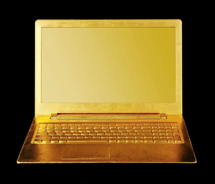 Article 3 by Nic Phillipson, a 2023 sculpture featuring a laptop computer gilded in 24 karat gold leaf