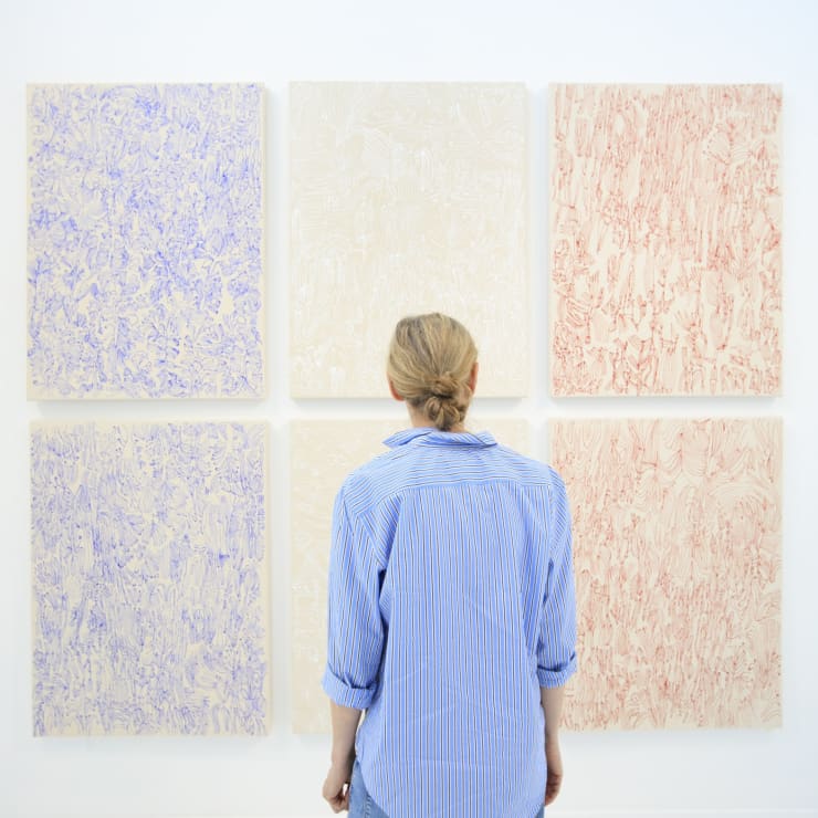 Artist Sarah Giannobile with paintings in "Tiger Moth" exhibition