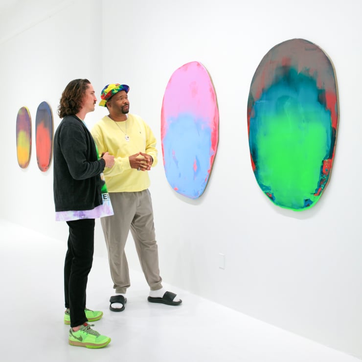 Nick Schleicher and guest viewing artworks in Point of Contact
