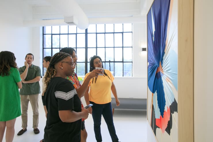 Dopamine installation view with guests featuring an original work from Carrie Gillen