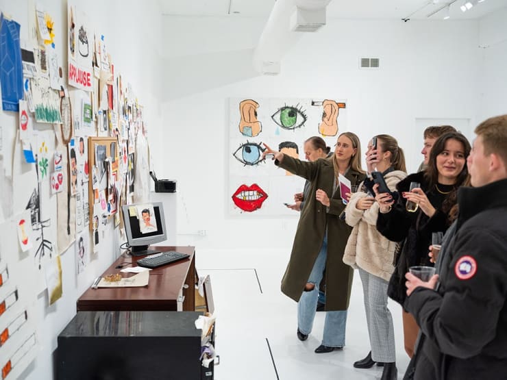 Guests at Sage Barnes's "Employee Of The Month" opening reception