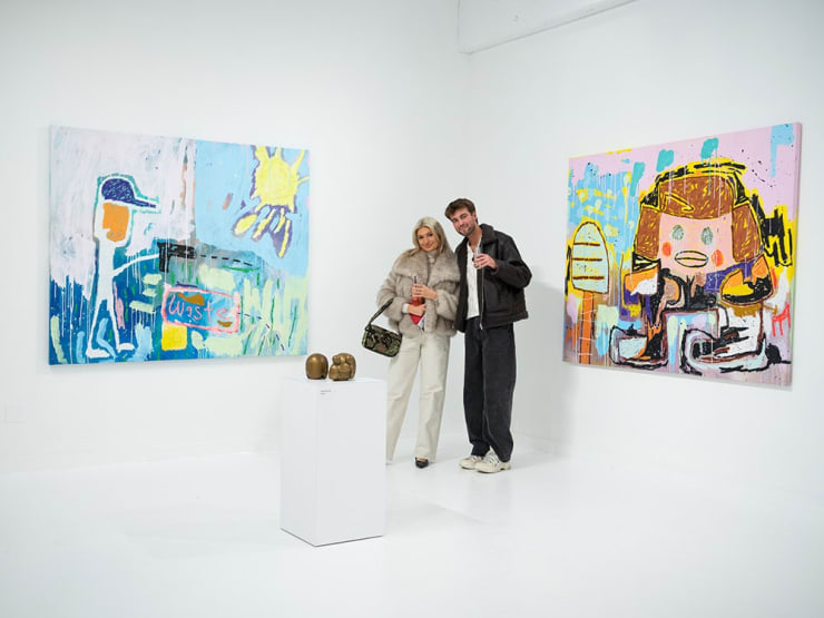 Guests at Adam Handler's "Eagle King" exhibition opening reception