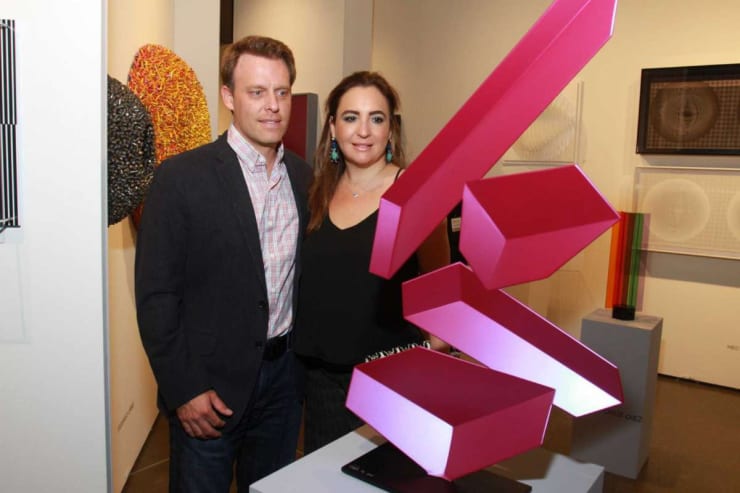 Arturo and Paola Creixell with a piece by artist Rafael Barrios titled "Tumble M388," at the Houston Fine Art Fair at NRG Center. Gary Fountain/For the Chronicle