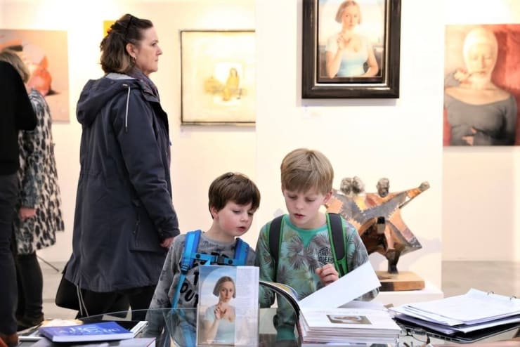 Rotterdam Contemporary Art Fair 2017 Kids watchig the artist catalogs on the booth of Lilja Zakirova Gallery