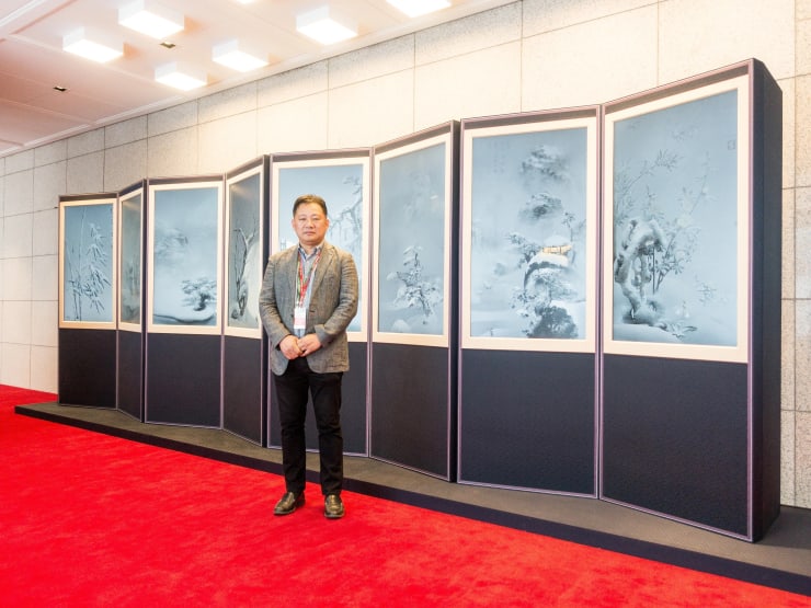 Lee Leenam stands in front of his work "The Way to Peace"