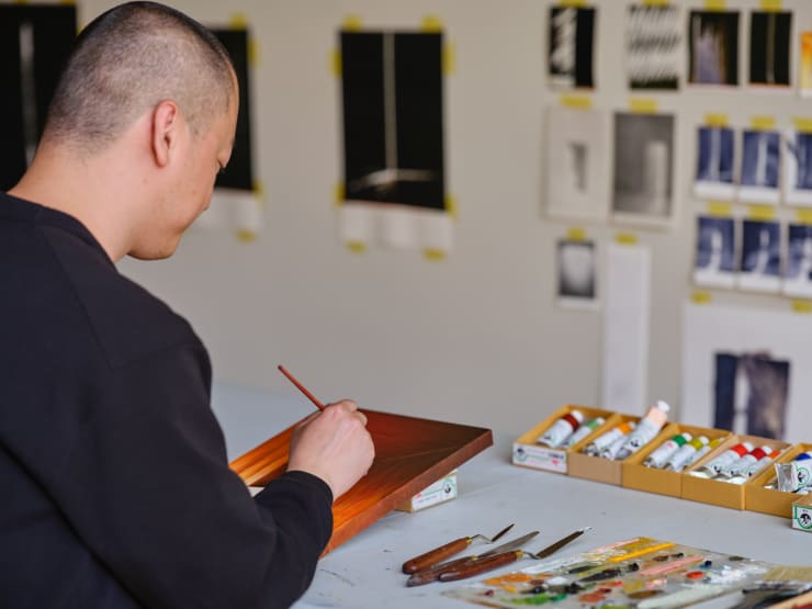 Szelit Cheung working in the Victorian town house for DOOR TO DOOR (2023). Photo: Nick Smith.