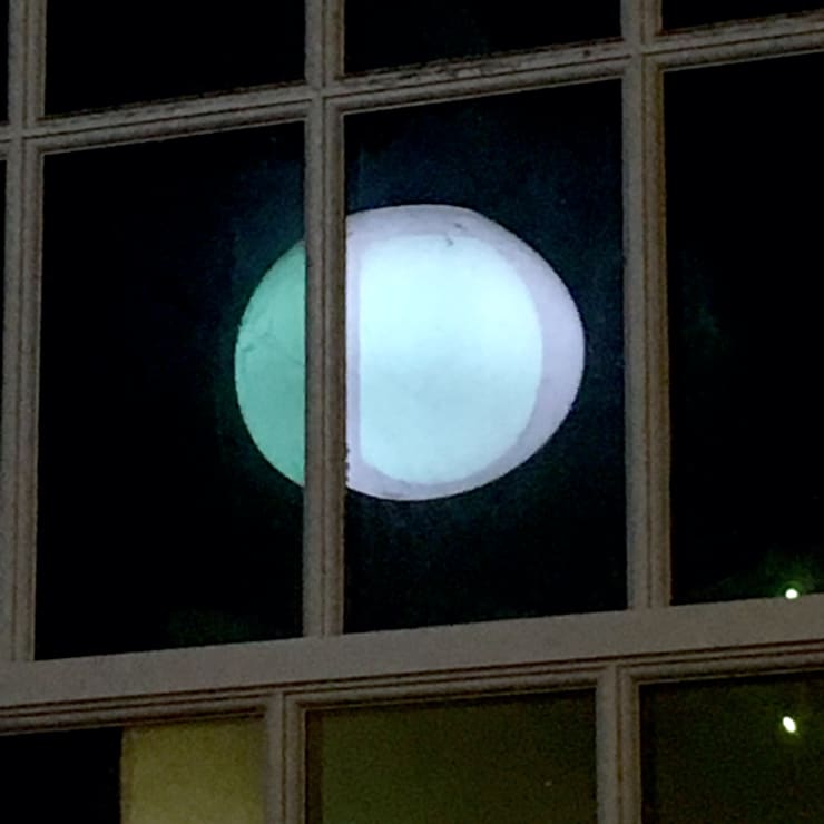 Chapterhouse café window, October of 2019, lamp reflection in the west-facing window at 8pm