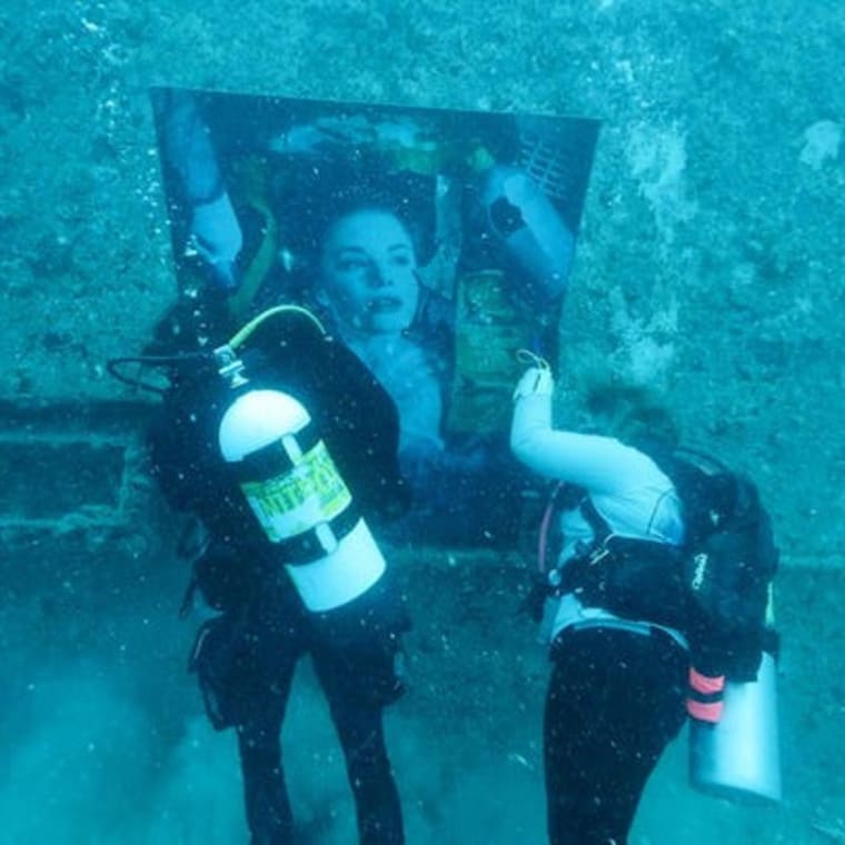 Divers hang "Plastic Ocean—Julia S" on the Vandenberg in the Florida Keys. Photo: Joe Berg/Florida Keys News Bureau via AP