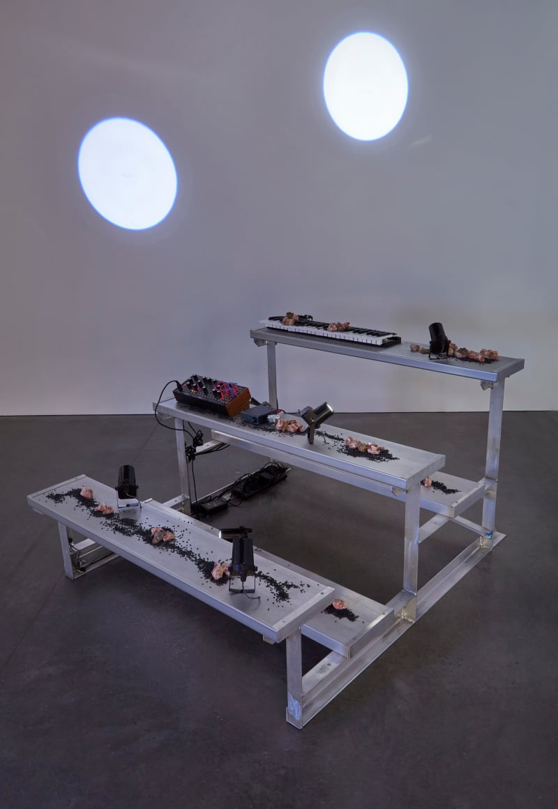 Nikita Gale HXSTXRICAL RECORD, 2022 Bleachers, keyboard, synthesizer, transducer, trilobite, shungite, calcite, spotlights, performance 35 x 47 1/4 x 53...