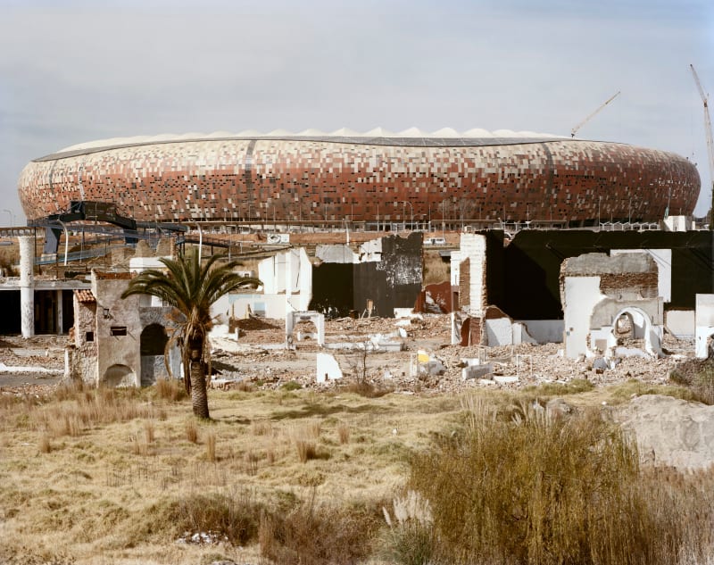 David Goldblatt The FNB Soccer City stadium built for the World Cup of July 2010, and the ruins of Shareworld...