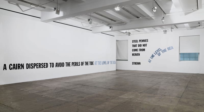 On the left wall near the bottom, black and blue text reads, a cairn dispersed to avoid the perils of the tide at the level of the sea; on the right wall to the left, black text reads, steel pennies that did not come from heaven strewn; on the right wall 