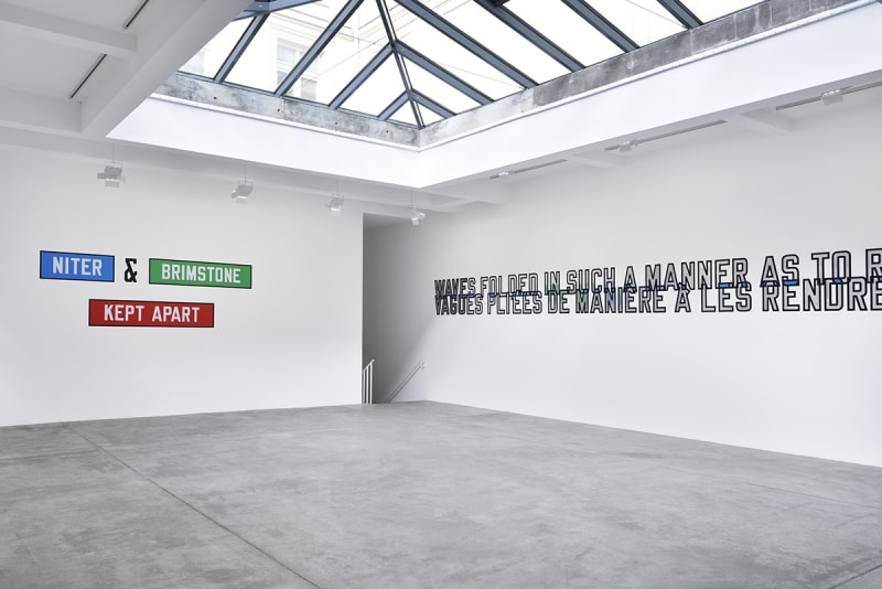 Multicolored text on the wall which reads "NITER & BRIMSTONE KEPT APART". Additional text is cut off on the right wall.