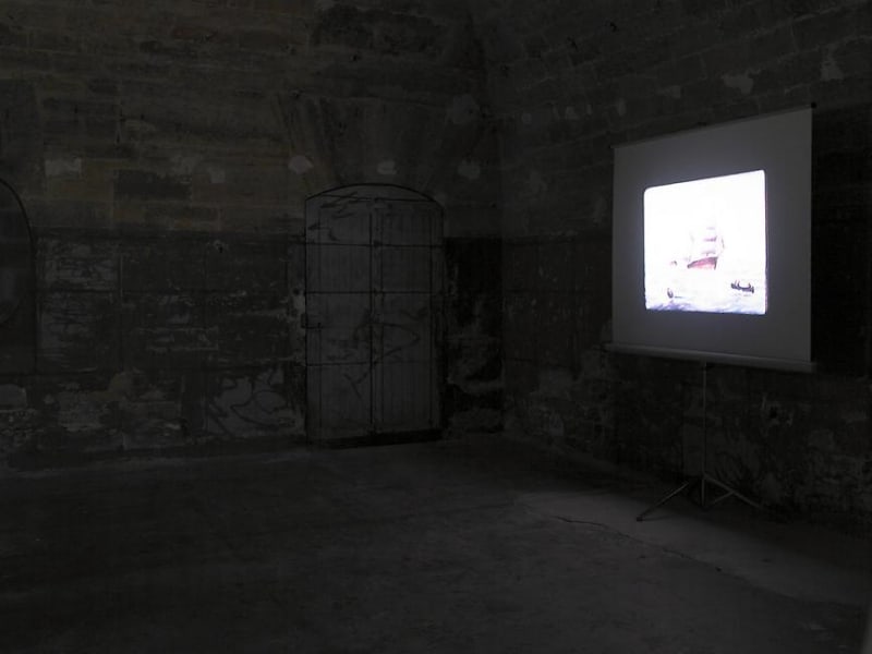 A projection on a screen in a darkened room, the content is unclear. 