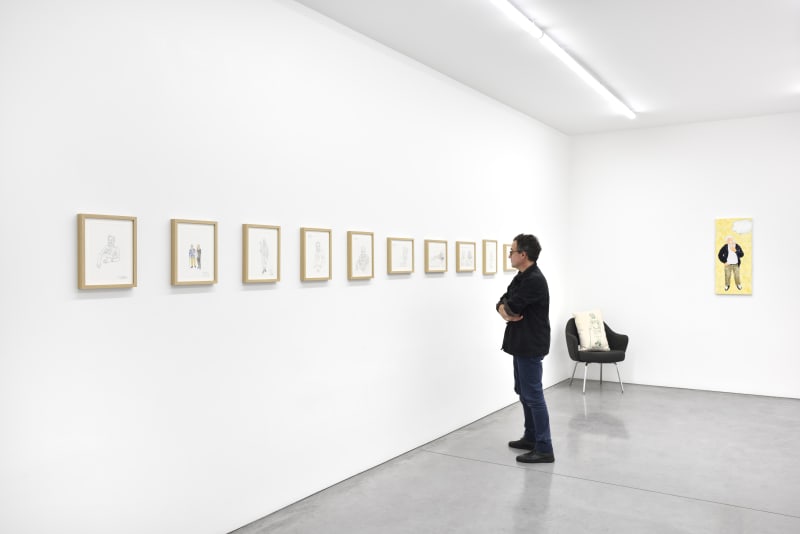 man looks at illustrations by Dan Graham