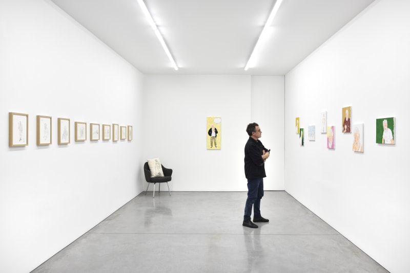 Man looks at illustrations by Dan Graham