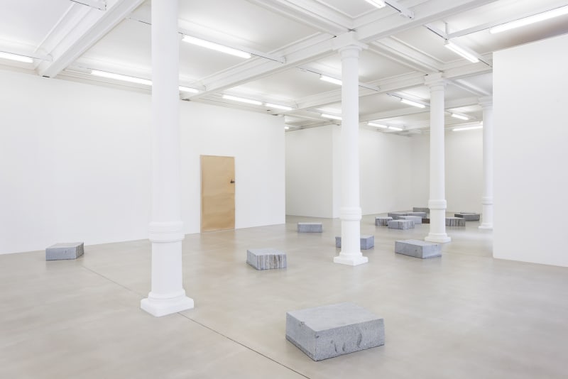 Gallery view, stone blocks arranged in gallery space.