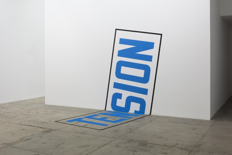 Blue text surrounded by a black box moving from the floor to the wall reading "TENSION"