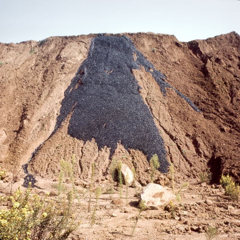 An earthwork by Robert Smithson: a truckload of hot asphalt poured down a steep embankment, which cooled and hardened as it fell.