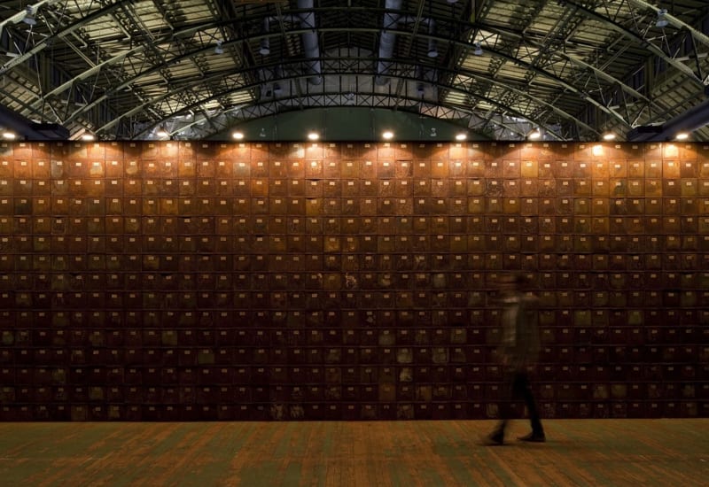 Wall of many rusted cabinets in warehouse.