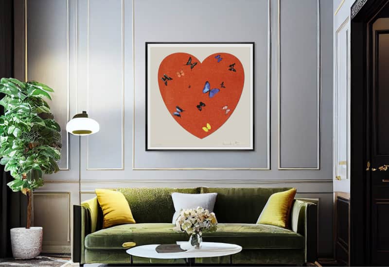 A painting from the Love Heart series by Damien Hirst hangs on a living room wall. The owner recently purchased this piece from Maddox Gallery, a consignment art gallery that specialises in fine art resale.