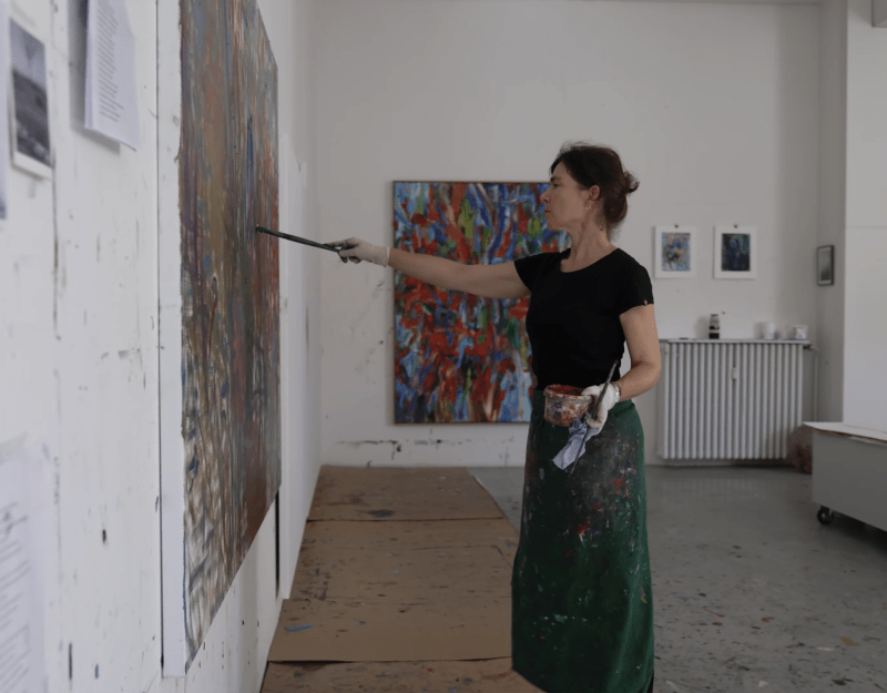 Artist Sabine Moritz painting in her studio